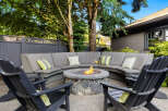 Enjoy outdoor living at its finest with this stunning property! Featuring a cozy fire pit surrounded by comfortable seating, perfect for entertaining or relaxing.
