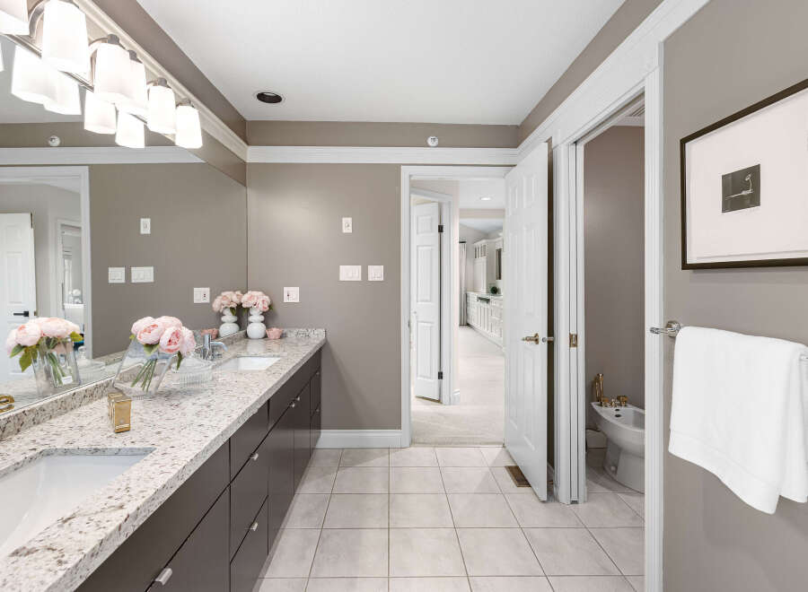 Step into luxury with this stunning bathroom, featuring a double vanity with a beautiful granite countertop and ample storage.