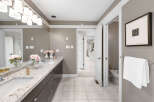 Step into luxury with this stunning bathroom, featuring a double vanity with a beautiful granite countertop and ample storage.