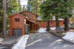 Nestled amidst towering trees, this charming home offers a serene mountain retreat.