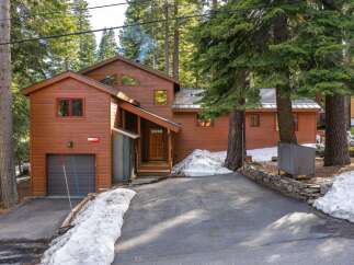 Nestled amidst towering trees, this charming home offers a serene mountain retreat.