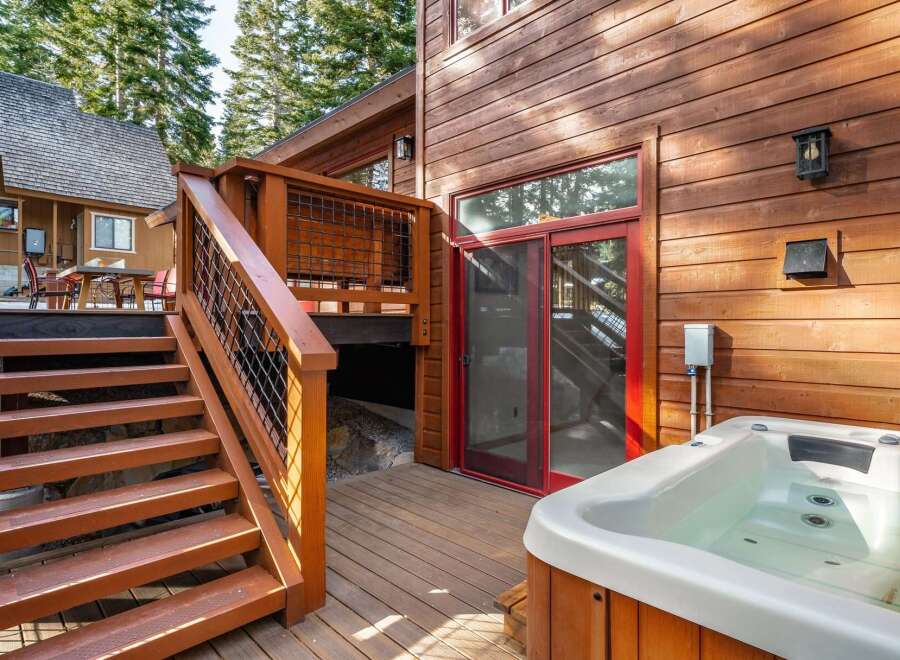 Enjoy luxury living with this stunning property featuring a private hot tub and a beautiful wooden deck.