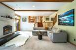 Step into luxury with this stunning property, featuring a cozy living room with a fireplace and a plush, inviting sofa.
