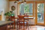 This stunning dining area features a beautiful wooden table and chairs, perfect for hosting gatherings.