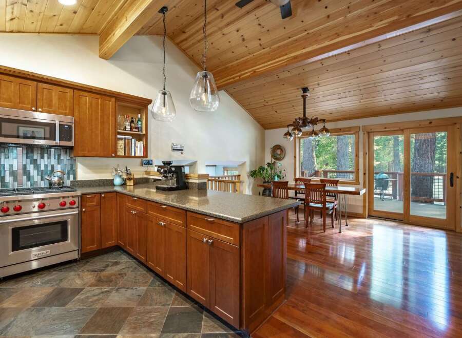 This stunning kitchen boasts a warm and inviting atmosphere, perfect for culinary enthusiasts.