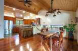 Step into this stunning home featuring a warm and inviting interior with beautiful hardwood floors and a vaulted wood ceiling.