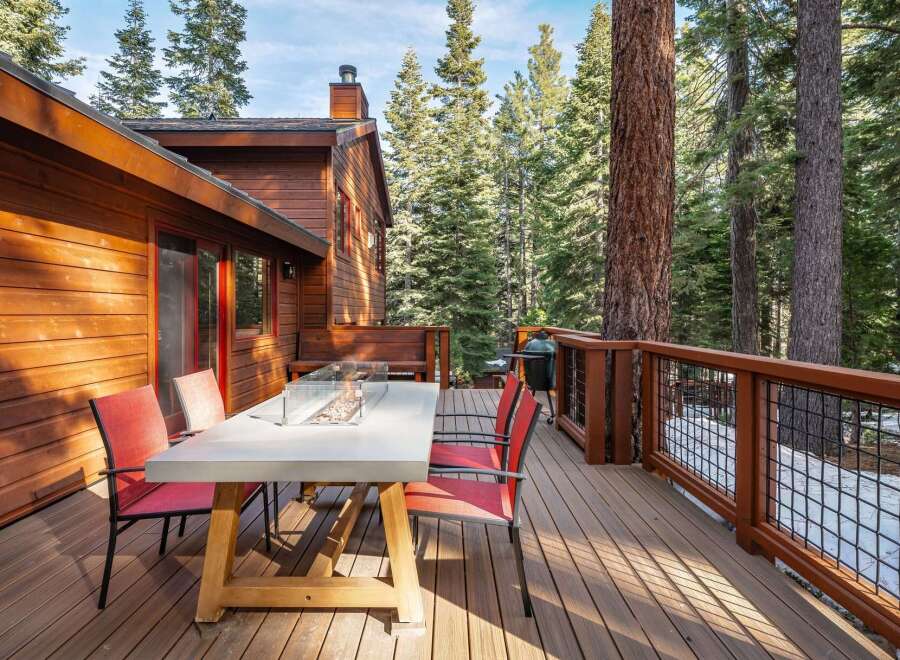 Enjoy the tranquility of this stunning property featuring a spacious deck perfect for outdoor dining and relaxation.