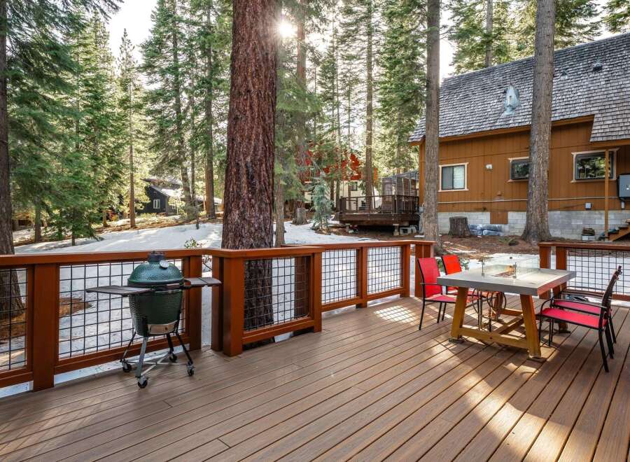 Enjoy the tranquility of this stunning property with a spacious deck, perfect for outdoor gatherings.