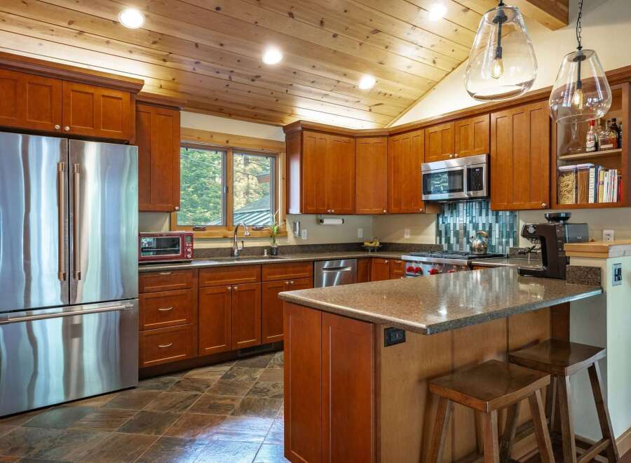 This stunning kitchen boasts a warm and inviting atmosphere with its rich wood cabinetry and granite countertops.