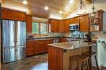 This stunning kitchen boasts a warm and inviting atmosphere with its rich wood cabinetry and granite countertops.