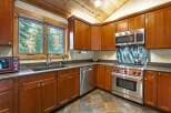 This stunning kitchen boasts a warm and inviting atmosphere, perfect for culinary enthusiasts.