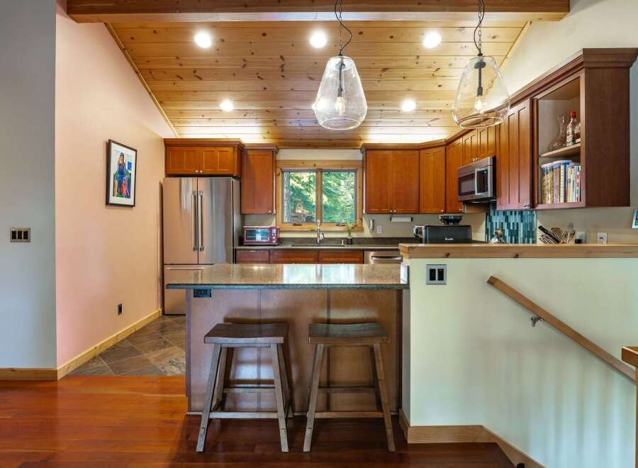 This stunning kitchen boasts a warm and inviting atmosphere with its wooden ceiling and cabinetry.