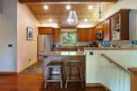 This stunning kitchen boasts a warm and inviting atmosphere with its wooden ceiling and cabinetry.