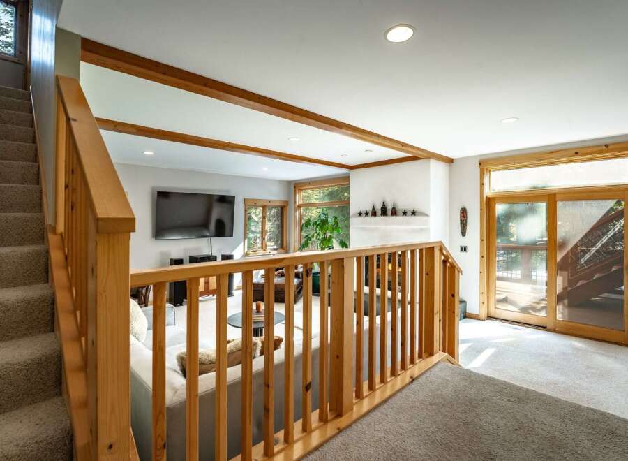 Step into this inviting living space, featuring a seamless blend of natural light and warm wooden accents.