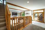 Step into this inviting living space, featuring a seamless blend of natural light and warm wooden accents.