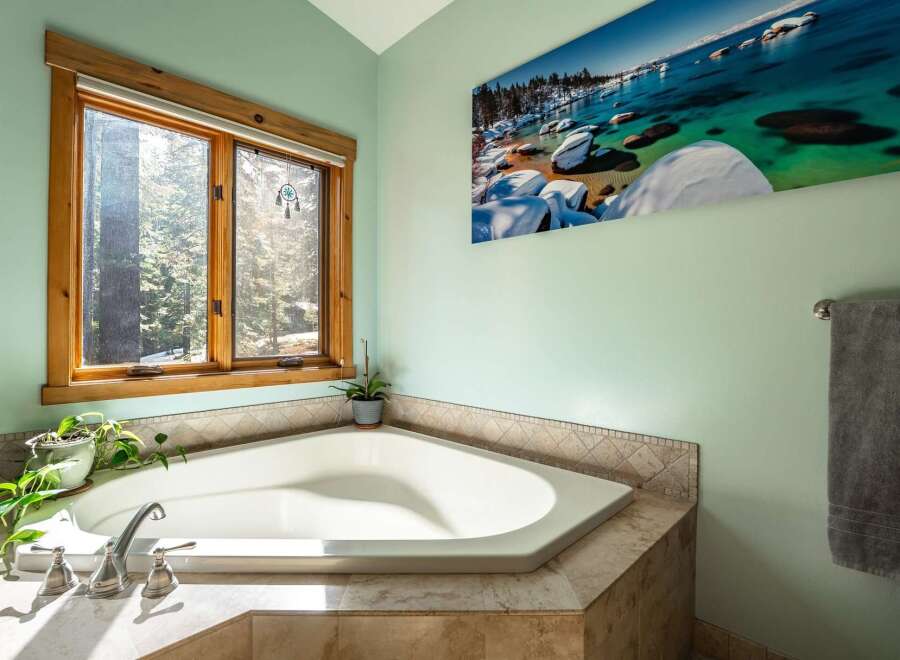 This luxurious bathroom features a stunning corner bathtub, perfect for relaxing after a long day.