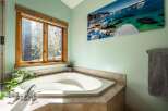 This luxurious bathroom features a stunning corner bathtub, perfect for relaxing after a long day.