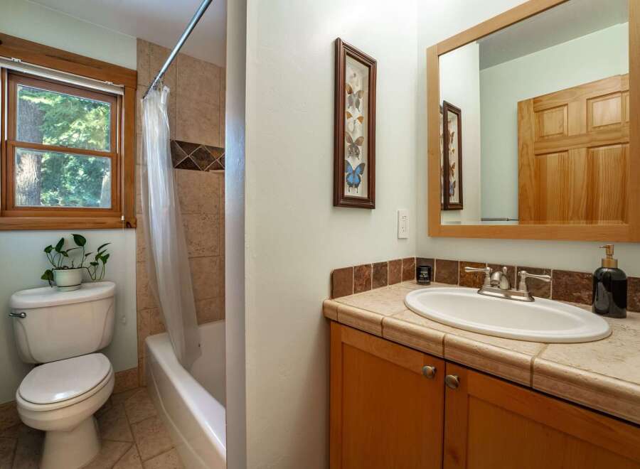 This charming bathroom features a bright window that allows natural light to flood the space.