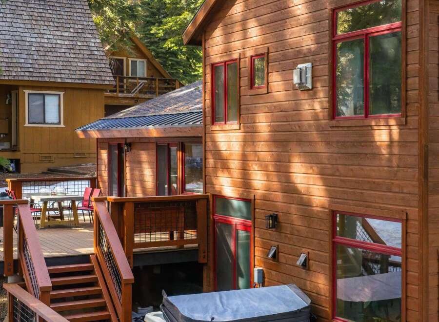 This stunning cabin boasts a beautiful wooden exterior and a relaxing hot tub, perfect for unwinding after a day of outdoor adventures.