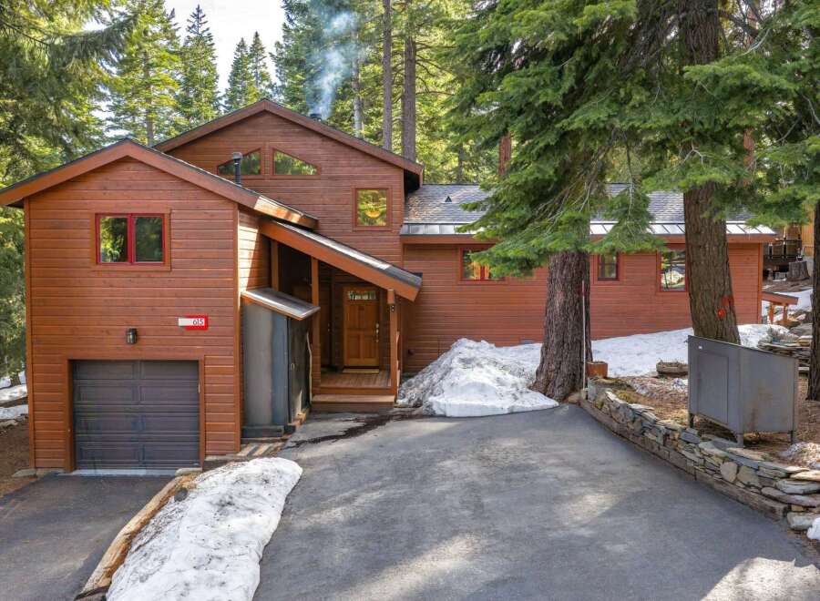 Nestled amidst towering trees, this stunning property offers a serene retreat.