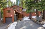 Nestled amidst towering trees, this stunning property offers a serene retreat.