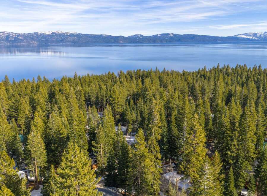 Discover a stunning property nestled amidst a lush forest with breathtaking lake views.