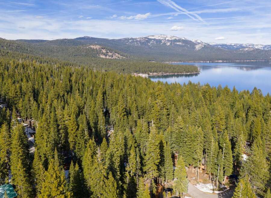 Discover the tranquility of this stunning property nestled amidst a lush forest and overlooking a serene lake.