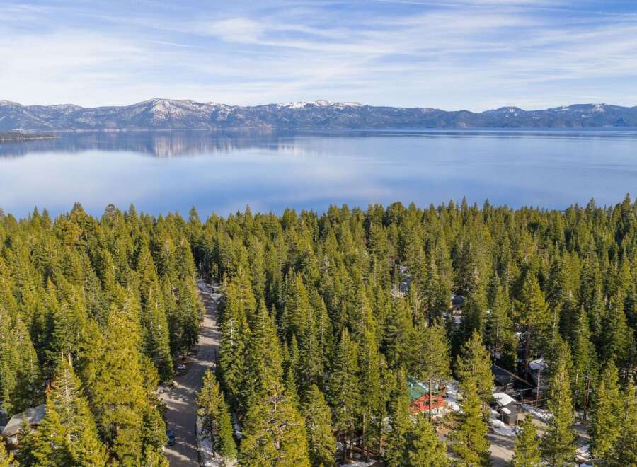 Discover a stunning property nestled amidst a lush forest with breathtaking lake views.