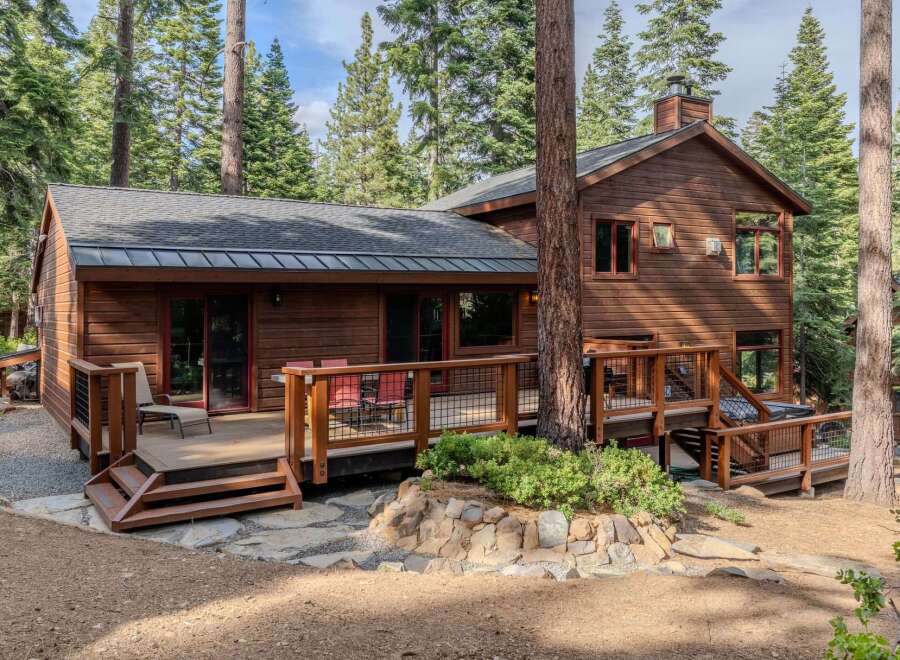 Nestled amidst towering pine trees, this charming wooden cabin offers a serene mountain retreat.