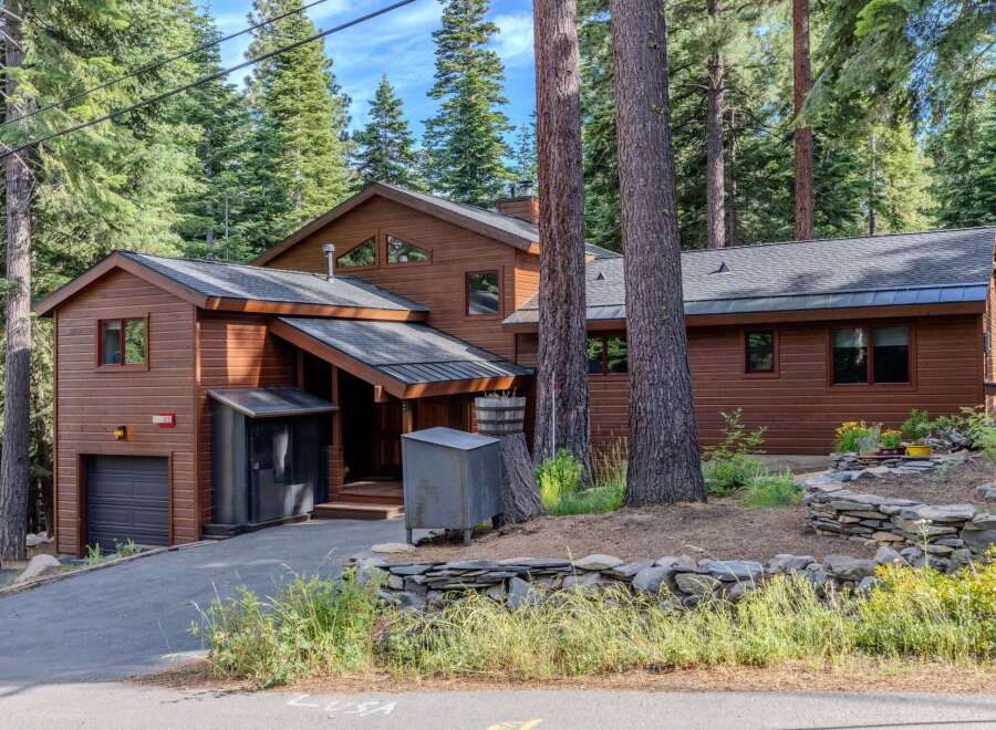 Nestled amidst towering pine trees, this charming wooden home offers a serene mountain retreat.