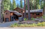 Nestled amidst towering pine trees, this charming wooden home offers a serene mountain retreat.