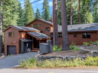 Nestled amidst towering pine trees, this charming wooden home offers a serene mountain retreat.