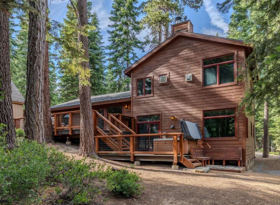 Nestled amongst towering pine trees, this charming wooden cabin offers a serene retreat.