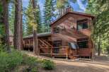 Nestled amongst towering pine trees, this charming wooden cabin offers a serene retreat.