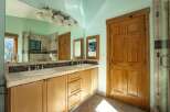 This spacious bathroom features a double vanity with ample counter space and two sinks, perfect for busy mornings.