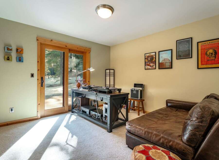 This room offers a dedicated space for music enthusiasts, featuring a DJ setup with turntables and audio equipment.