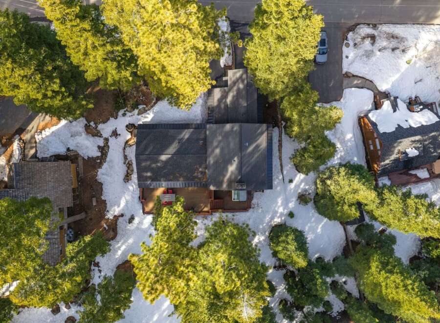 Nestled amidst towering pine trees and a winter wonderland, this property offers a serene escape.