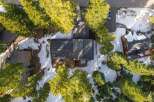 Nestled amidst towering pine trees and a winter wonderland, this property offers a serene escape.