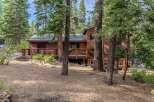 Nestled amongst tall pine trees, this charming wooden cabin offers a serene mountain retreat.