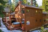 Experience mountain living in this stunning wooden home, nestled amongst tall pine trees.