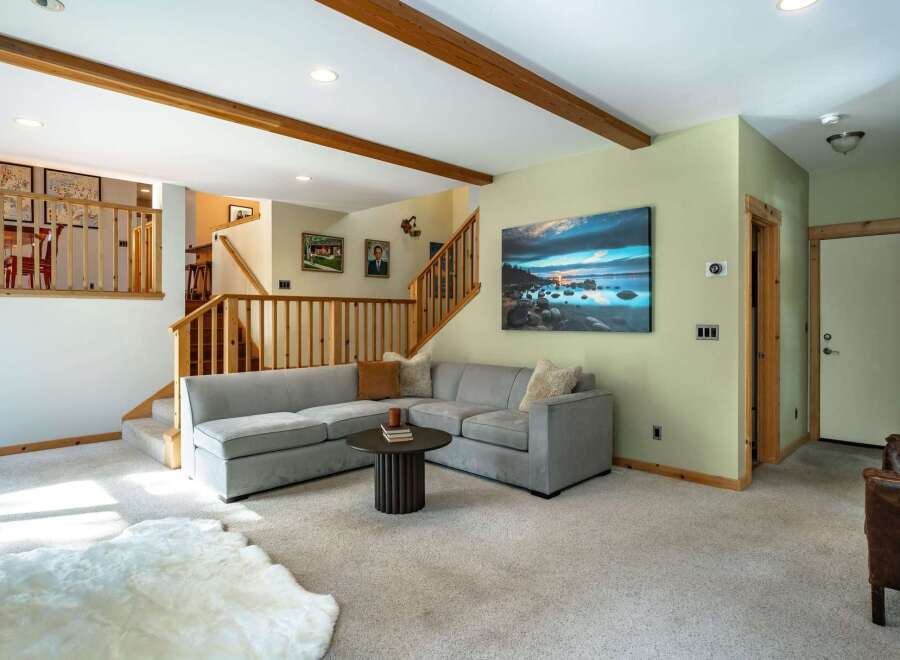 This inviting living room features a spacious sectional sofa perfect for gathering, complemented by a stylish round coffee table.