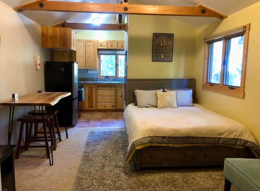 This charming studio apartment offers a cozy retreat with a well-equipped kitchenette and a comfortable queen-sized bed.