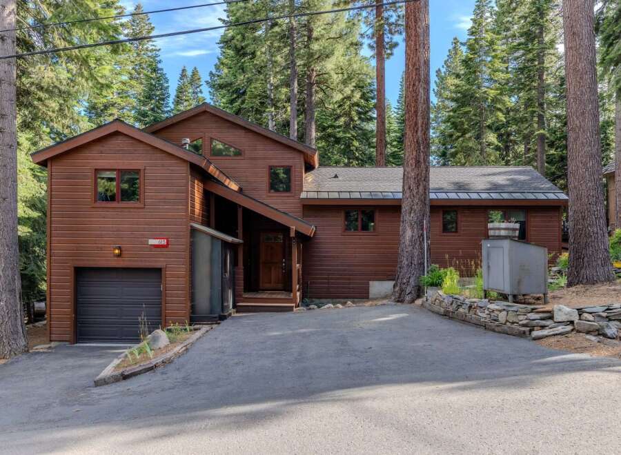 Nestled among tall pine trees, this charming wooden home offers a serene mountain retreat.