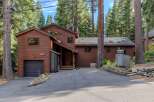 Nestled among tall pine trees, this charming wooden home offers a serene mountain retreat.