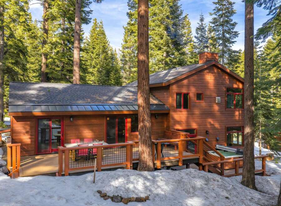 Nestled amidst towering pine trees, this charming wooden home offers a serene mountain retreat.