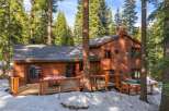 Nestled amidst towering pine trees, this charming wooden home offers a serene mountain retreat.