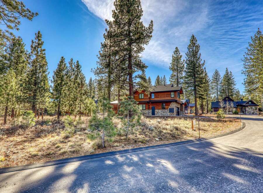 Nestled amidst towering trees, this stunning property offers a serene escape.