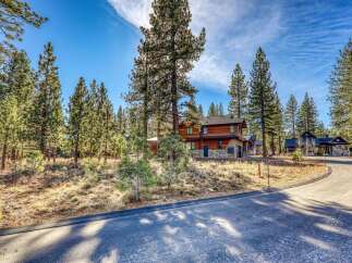 Nestled amidst towering trees, this stunning property offers a serene escape.