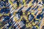 Discover a stunning aerial view of a luxurious neighborhood featuring modern homes with dark gray roofs.