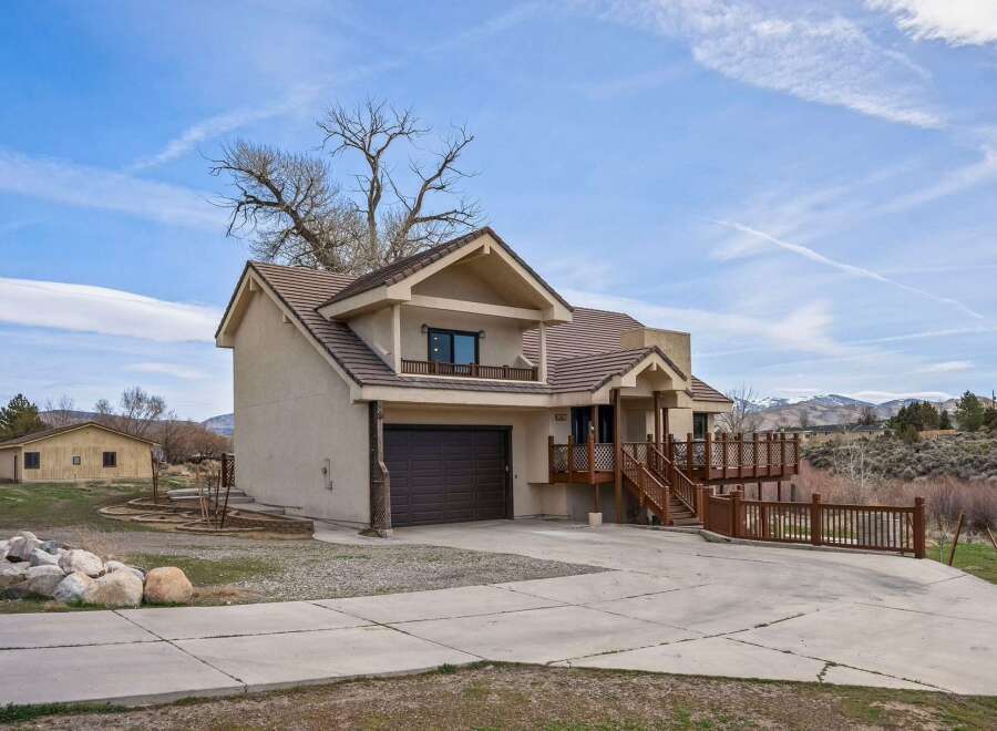 Discover this stunning property featuring a spacious two-story home with a charming balcony and a convenient garage.